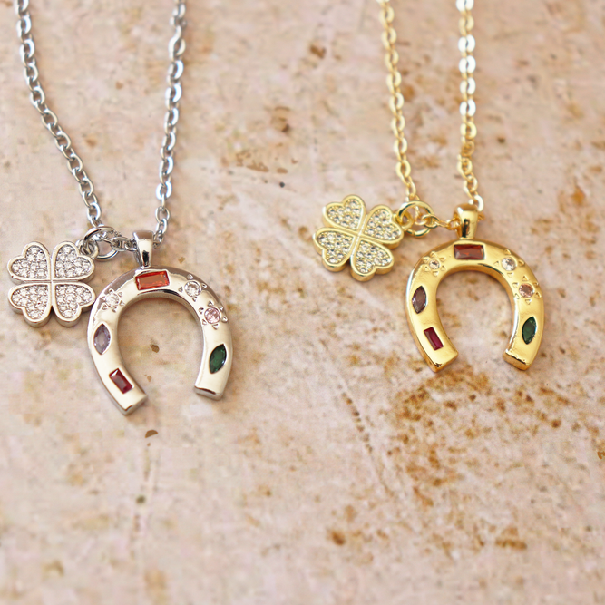 The Lucky One charm necklace in silver and gold with clover and horseshoe pendants