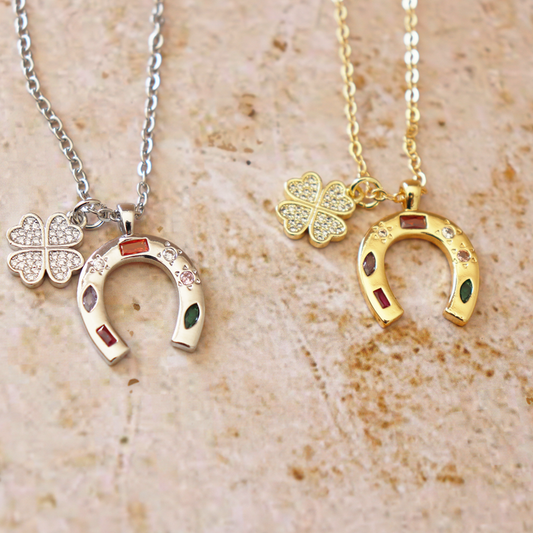The Lucky One charm necklace in silver and gold with clover and horseshoe pendants